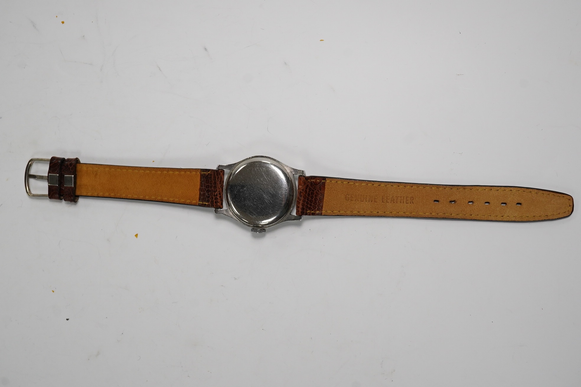 A gentleman's steel Longines manual wind wrist watch, with Arabic and baton numerals, and subsidiary seconds, movement c.11L, case diameter 30mm, on a later associated leather strap. Condition - poor